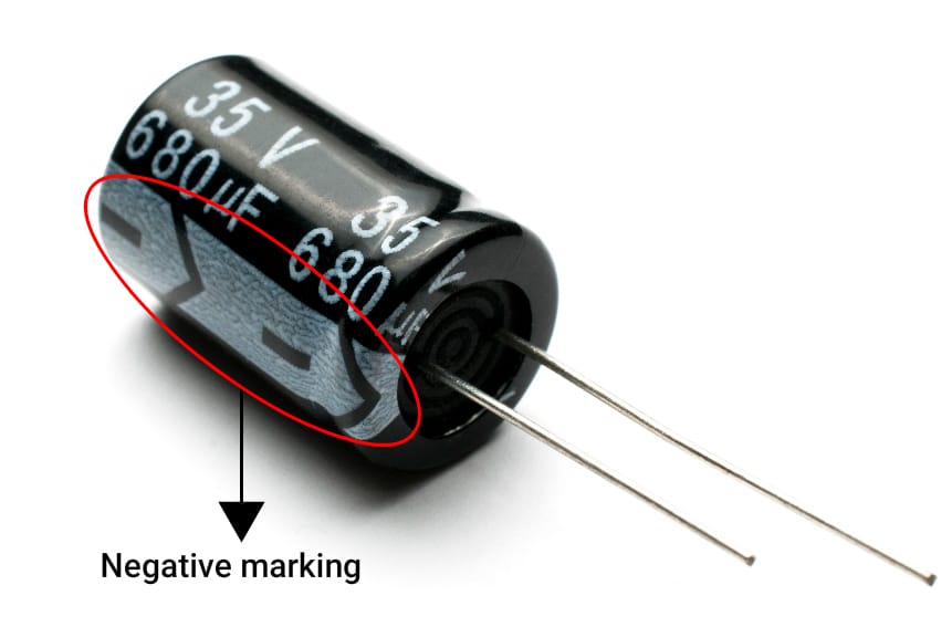 Electrolytic capacitor showing capacitance, voltage, and polarity markings